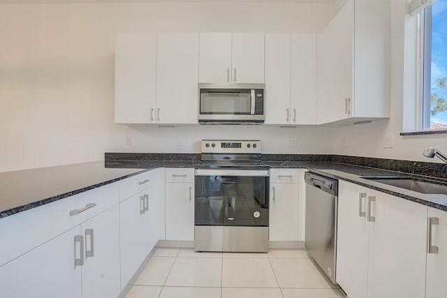340 Pioneer Way, Royal Palm Beach, FL 33411 - kitchen with a sink, dark stone countertops, a wealth of natural light, and stainless steel appliances