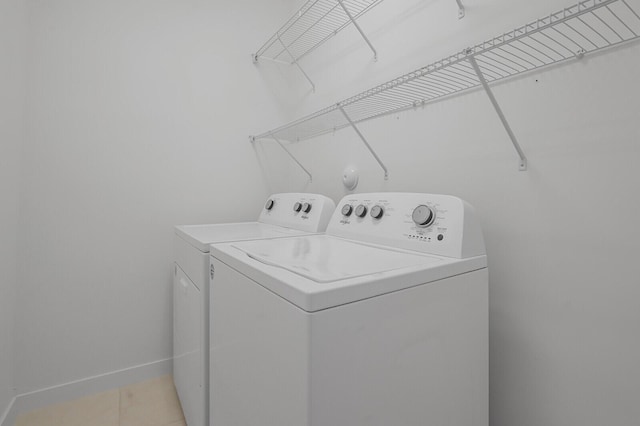 340 Pioneer Way, Royal Palm Beach, FL 33411 - clothes washing area with light tile patterned flooring, laundry area, washing machine and dryer, and baseboards