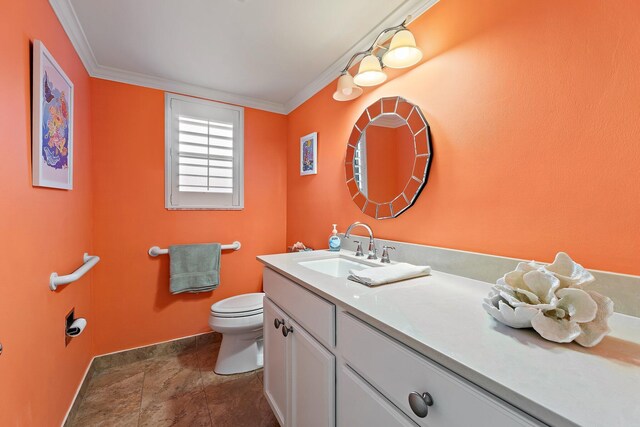 bathroom with baseboards, toilet, vanity, and crown molding