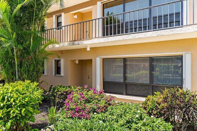 doorway to property featuring a balcony and stucco siding