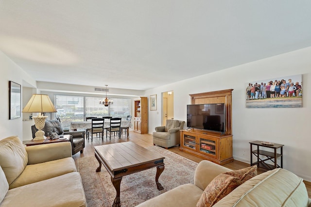 living room with a chandelier and light wood-style flooring