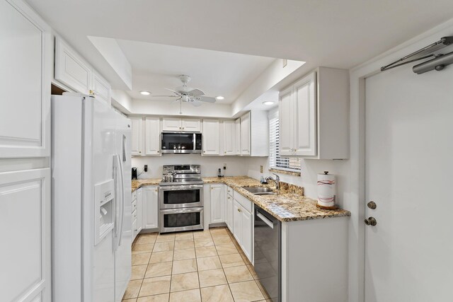 kitchen featuring appliances with stainless steel finishes, recessed lighting, light tile patterned floors, ceiling fan, and white cabinets