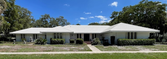single story home with covered porch and brick siding