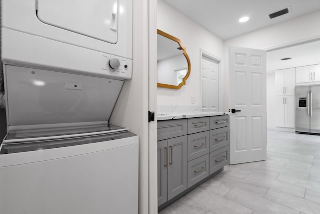 1625 Seaway Dr, Hutchinson Island, FL 34949 - clothes washing area with stacked washer / drying machine and recessed lighting