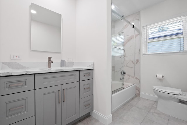 1625 Seaway Dr, Hutchinson Island, FL 34949 - full bath featuring toilet, baseboards, vanity, and enclosed tub / shower combo