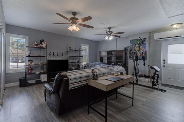 living room with baseboards, ceiling fan, a healthy amount of sunlight, and a wall mounted air conditioner