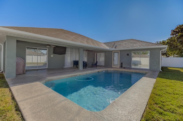 view of pool featuring a ceiling fan, a lawn, fence, a fenced in pool, and a patio