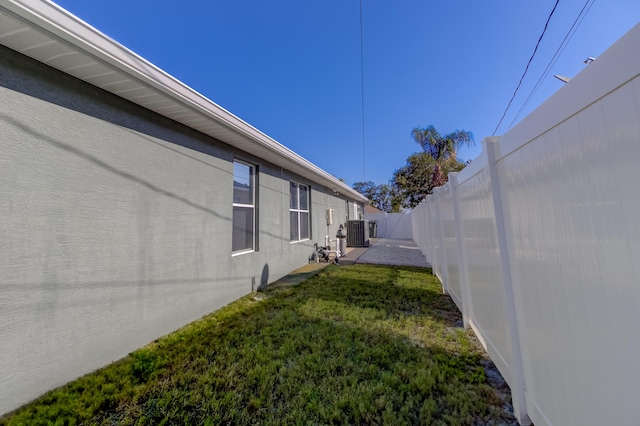 view of yard featuring central AC and a fenced backyard