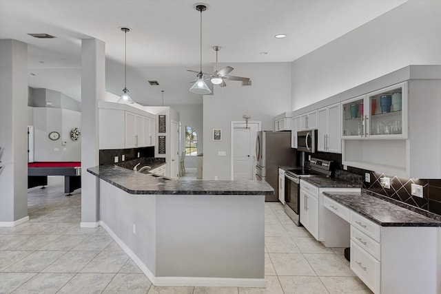 kitchen with ceiling fan, tasteful backsplash, light tile patterned floors, glass insert cabinets, and stainless steel appliances