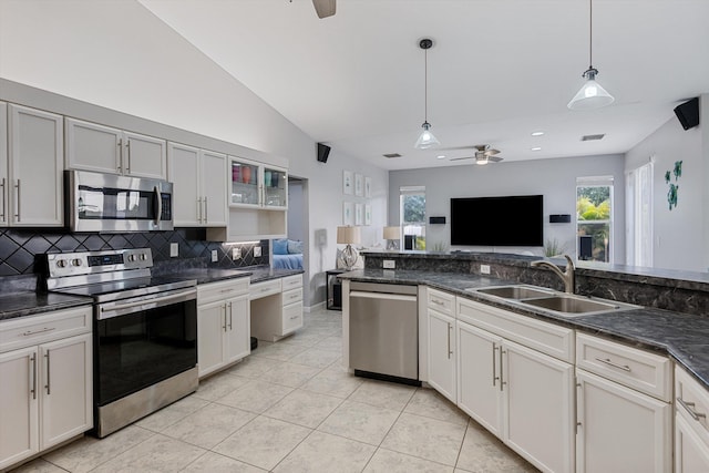 kitchen featuring ceiling fan, decorative backsplash, appliances with stainless steel finishes, a sink, and light tile patterned floors