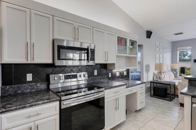 kitchen featuring stainless steel appliances, open floor plan, lofted ceiling, tasteful backsplash, and visible vents