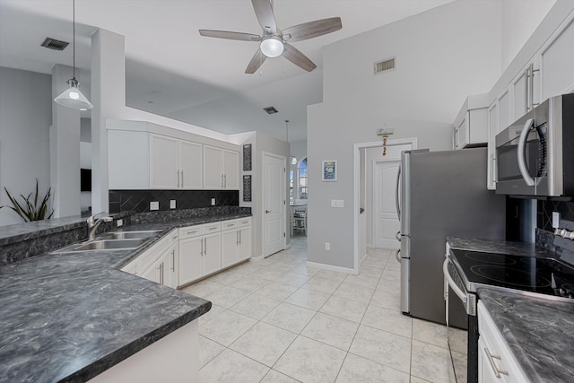 kitchen featuring a sink, appliances with stainless steel finishes, backsplash, and visible vents