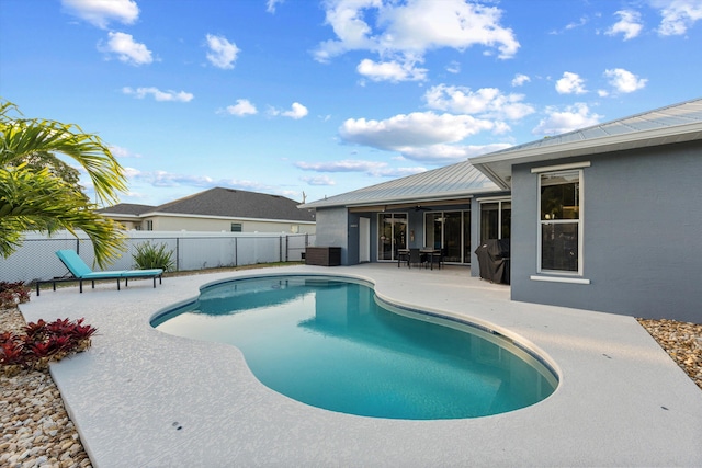 view of swimming pool with a patio, fence, a ceiling fan, and a fenced in pool