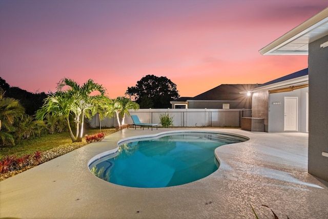 pool at dusk with a fenced in pool, fence, and a patio