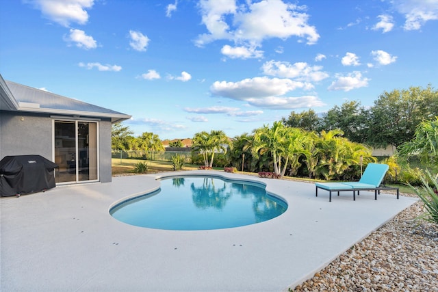 view of pool featuring a fenced in pool, a patio area, fence, and grilling area