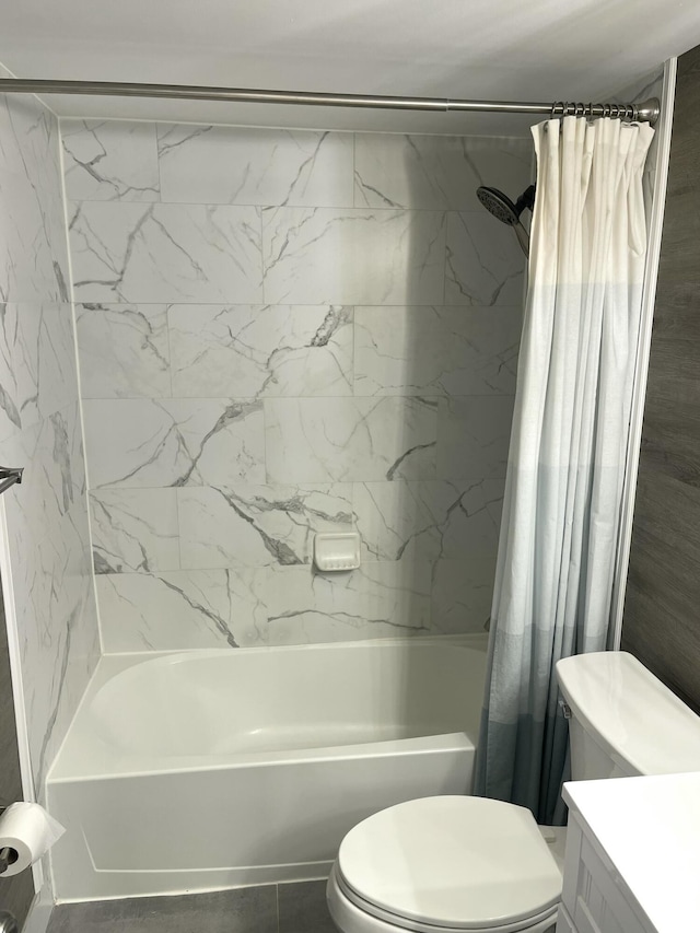 bathroom featuring toilet, shower / bath combo with shower curtain, and vanity