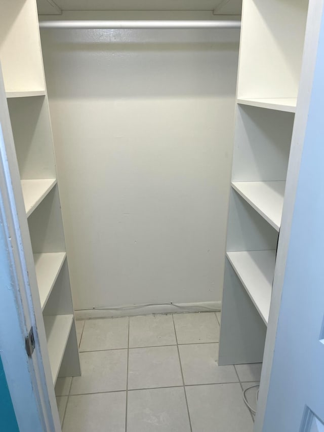 spacious closet featuring light tile patterned floors