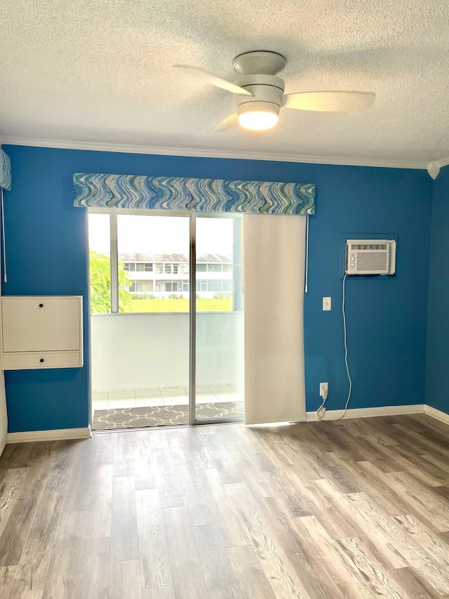 empty room featuring a ceiling fan, a textured ceiling, and wood finished floors