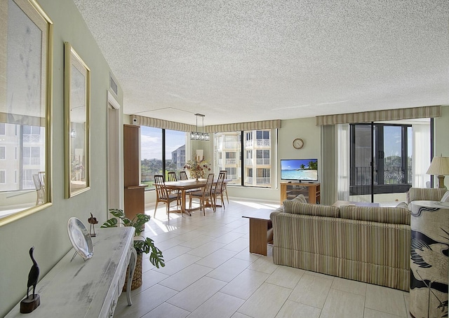 living area with a textured ceiling and light tile patterned floors