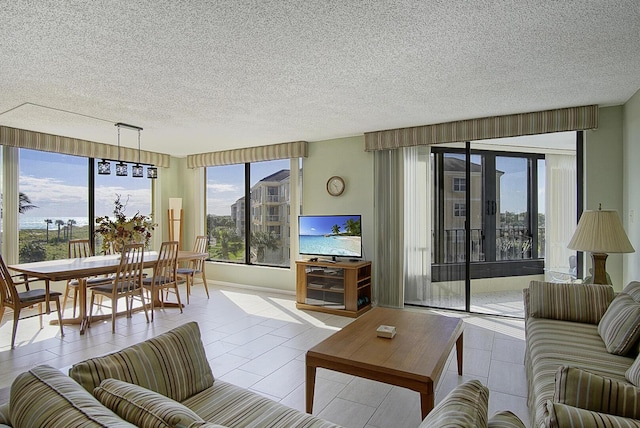tiled living area featuring a textured ceiling and a healthy amount of sunlight