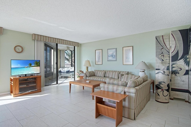 living room featuring light tile patterned floors and a textured ceiling