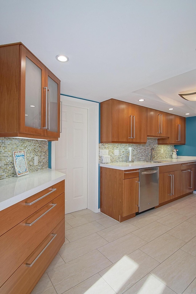 kitchen with brown cabinetry, light countertops, and dishwasher