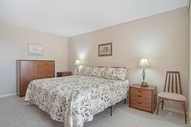 bedroom featuring light tile patterned floors and baseboards