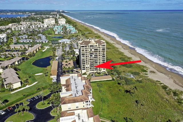 bird's eye view with a water view and a beach view