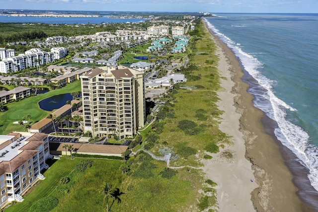 drone / aerial view featuring a beach view and a water view