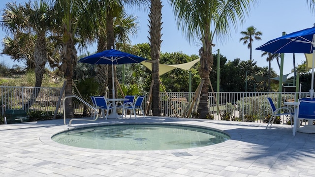 view of swimming pool featuring fence, a swimming pool, a patio, and outdoor dining area