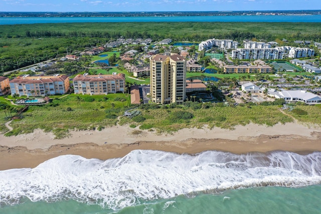 drone / aerial view featuring a beach view and a water view