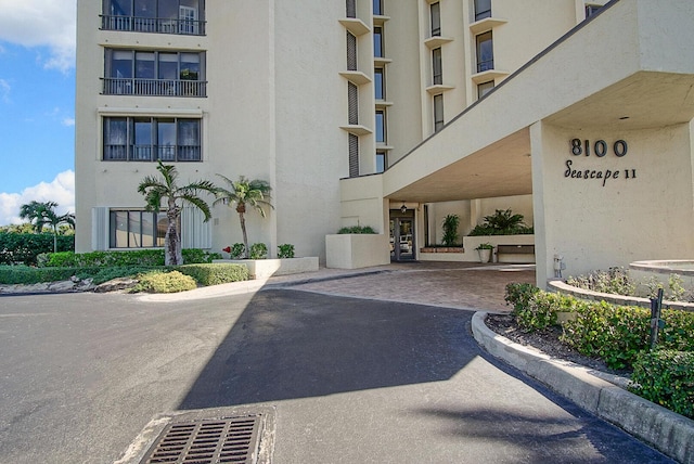 exterior space featuring visible vents, driveway, and stucco siding