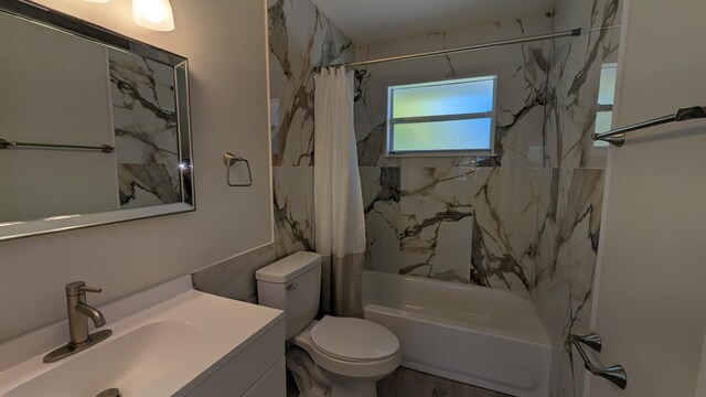 bathroom with vanity, shower / bath combo, and toilet