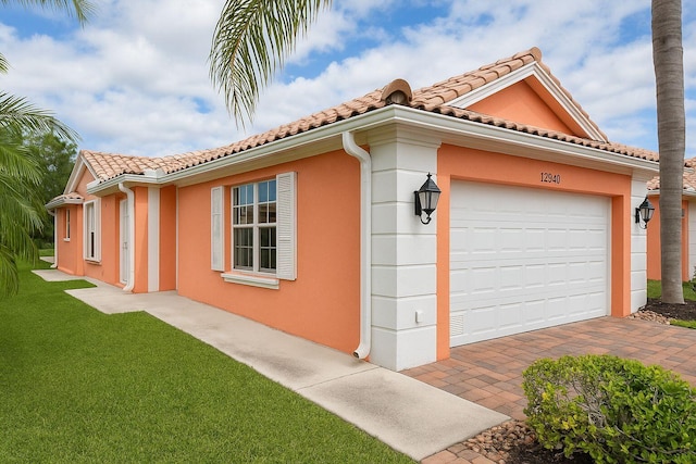12040 SW Elsinore Dr, Port Saint Lucie, FL 34987 - view of side of property featuring a lawn, stucco siding, and a tile roof