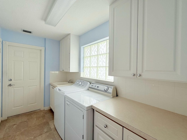 12040 SW Elsinore Dr, Port Saint Lucie, FL 34987 - laundry room with a sink, washer and dryer, cabinet space, and visible vents
