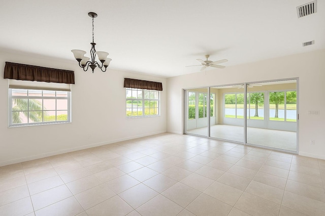 12040 SW Elsinore Dr, Port Saint Lucie, FL 34987 - spare room featuring baseboards, visible vents, light tile patterned floors, and ceiling fan with notable chandelier