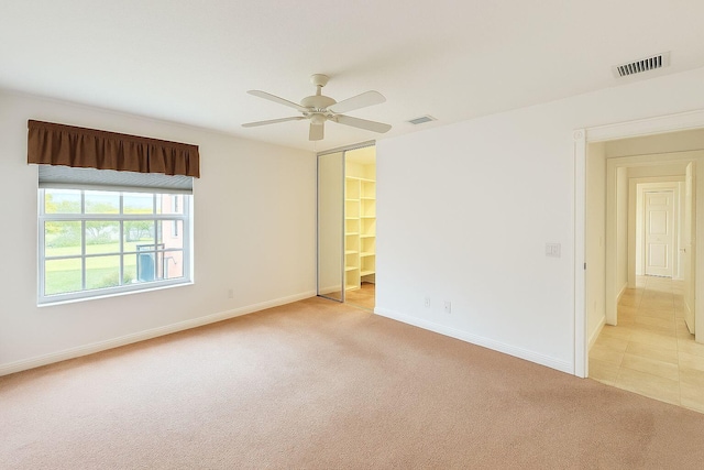 12040 SW Elsinore Dr, Port Saint Lucie, FL 34987 - spare room featuring visible vents, a ceiling fan, and light colored carpet