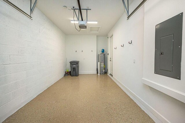 garage with a garage door opener, water heater, and electric panel