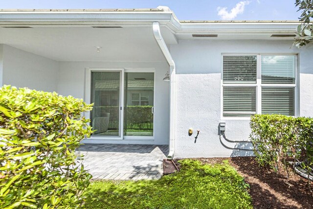 doorway to property with stucco siding