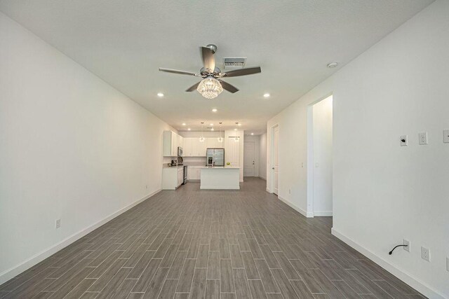 unfurnished living room with ceiling fan, dark wood-style flooring, visible vents, baseboards, and recessed lighting