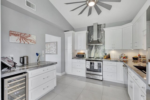 3399 Jog Park Dr, Greenacres, FL 33467 - kitchen with visible vents, wine cooler, wall chimney exhaust hood, a ceiling fan, and appliances with stainless steel finishes