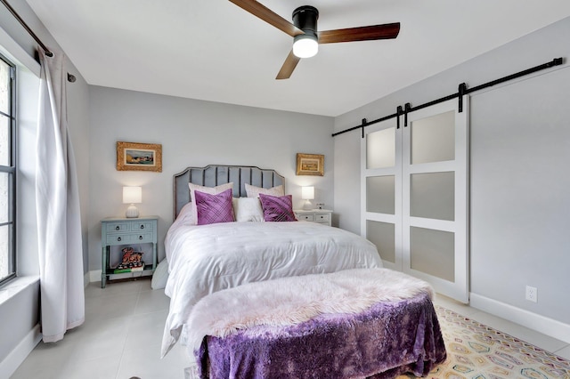3399 Jog Park Dr, Greenacres, FL 33467 - bedroom featuring light tile patterned floors, baseboards, ceiling fan, and a barn door