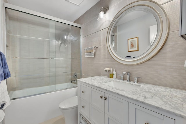3399 Jog Park Dr, Greenacres, FL 33467 - full bathroom with vanity, toilet, tile walls, combined bath / shower with glass door, and tasteful backsplash