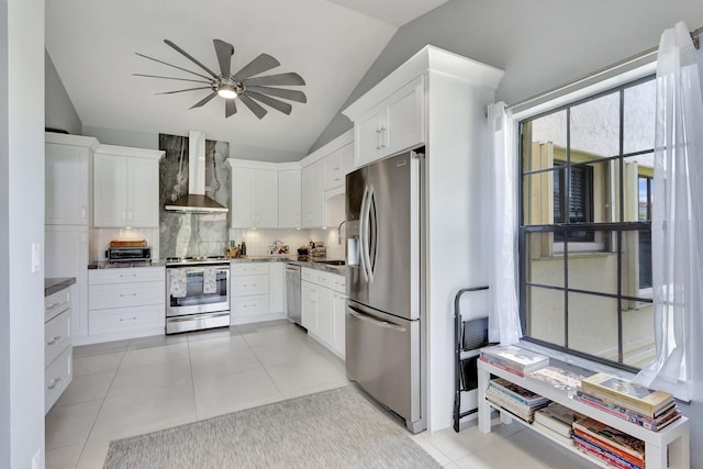 3399 Jog Park Dr, Greenacres, FL 33467 - kitchen featuring ceiling fan, wall chimney exhaust hood, tasteful backsplash, appliances with stainless steel finishes, and vaulted ceiling