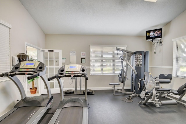 3399 Jog Park Dr, Greenacres, FL 33467 - gym featuring a textured ceiling and baseboards