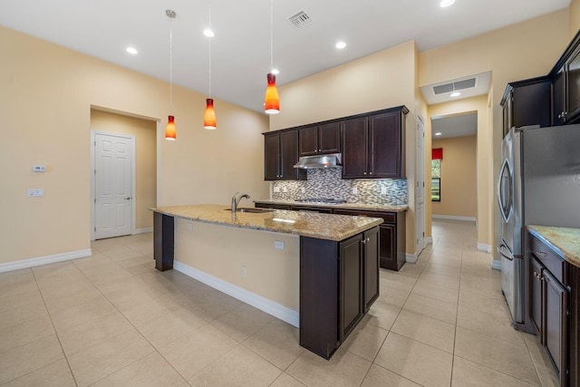10765 Pisa Rd, Wellington, FL 33414 - kitchen featuring visible vents, appliances with stainless steel finishes, under cabinet range hood, and backsplash