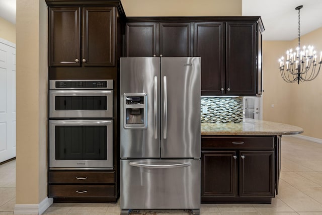 10765 Pisa Rd, Wellington, FL 33414 - kitchen featuring dark brown cabinets, light stone countertops, baseboards, a notable chandelier, and stainless steel appliances