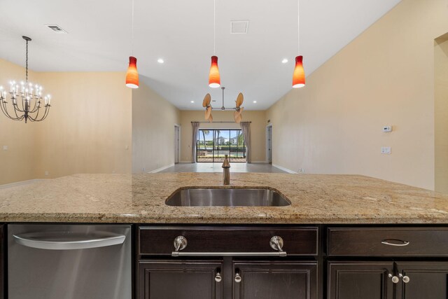 10765 Pisa Rd, Wellington, FL 33414 - kitchen with dark brown cabinetry, light stone countertops, a sink, stainless steel dishwasher, and visible vents
