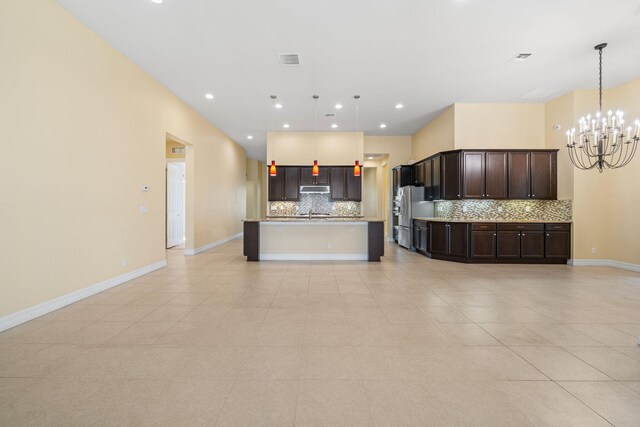 10765 Pisa Rd, Wellington, FL 33414 - empty room featuring baseboards, visible vents, light tile patterned flooring, and a chandelier