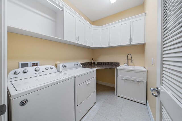 10765 Pisa Rd, Wellington, FL 33414 - laundry area with washer and dryer, light tile patterned floors, a sink, cabinet space, and baseboards